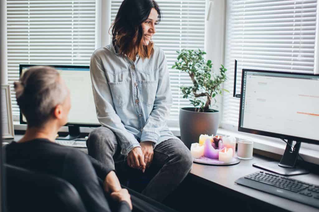 woman sits in front of computer